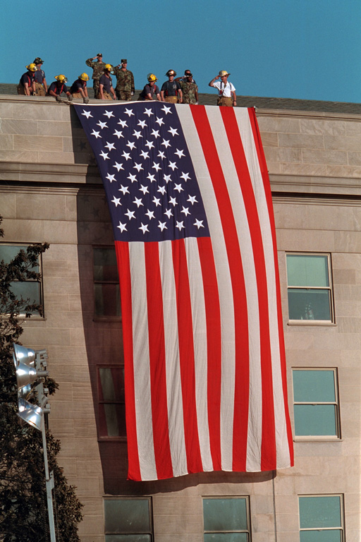 A large American flag hangs from the Pentagon. Flags and flag imagery were everywhere as the nation tried to move forward following the attacks.  George W. Bush Presidential Library.