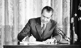 President Richard Nixon signing a document. National Archives and Records Service. 