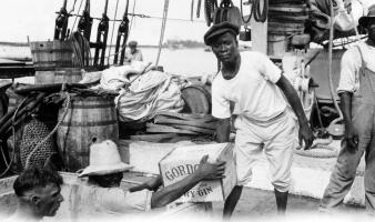 Men loading gin aboard a ship