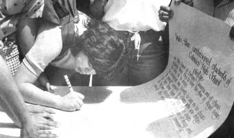 Student signs a drug-free pledge.