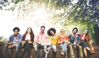 Smiling teens sitting together. 