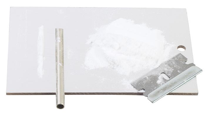 A scale, razor blade, and sifter used to prepare cocaine for sale