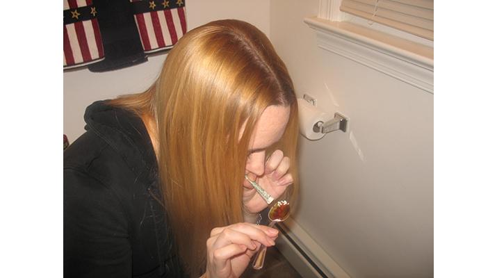 A girl freebase smoking cocaine.