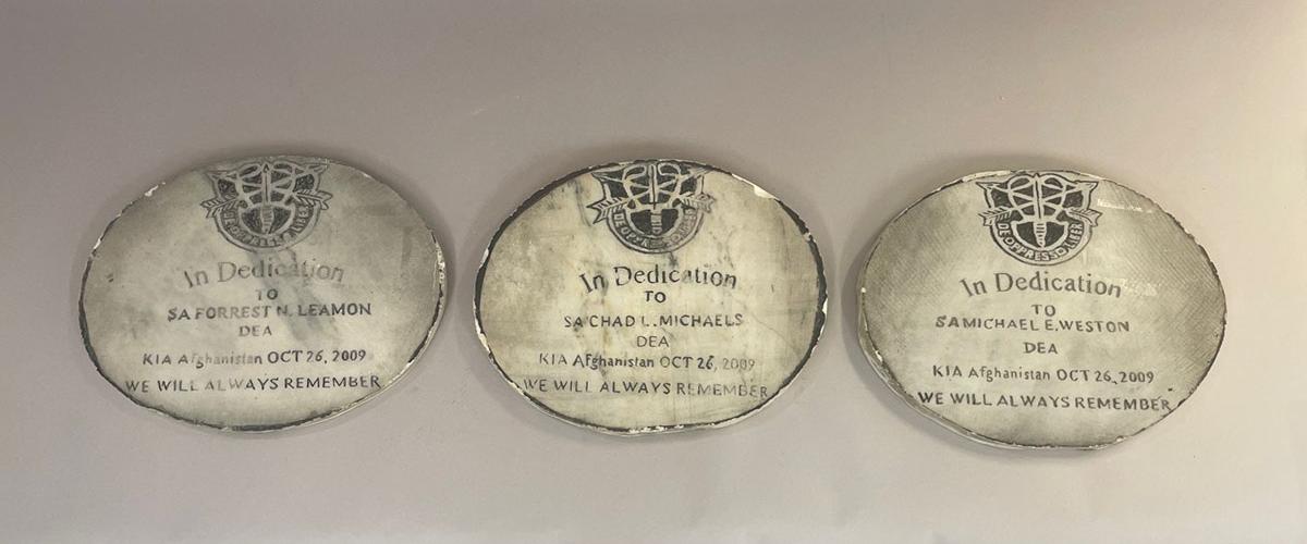   3 circular stones with names of three deceased special agents
