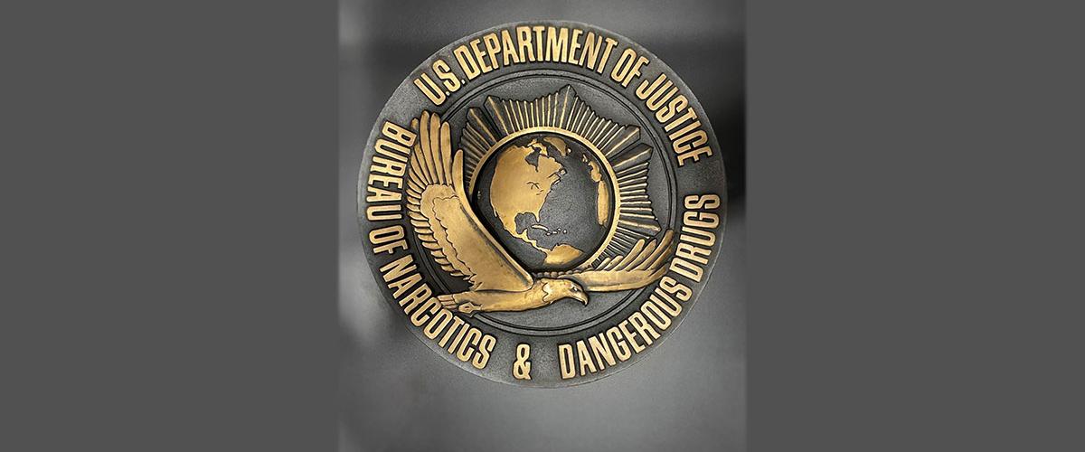   dark bronze plaque with BNDD seal
