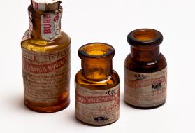 Three mid-20th century heroin bottles.