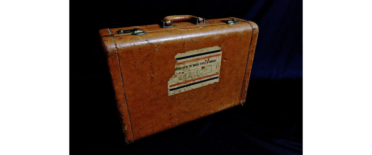 A tan leather suitcase