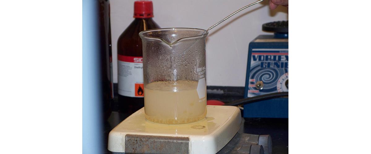 A beaker containing a mixture of water, cocaine, and baking soda