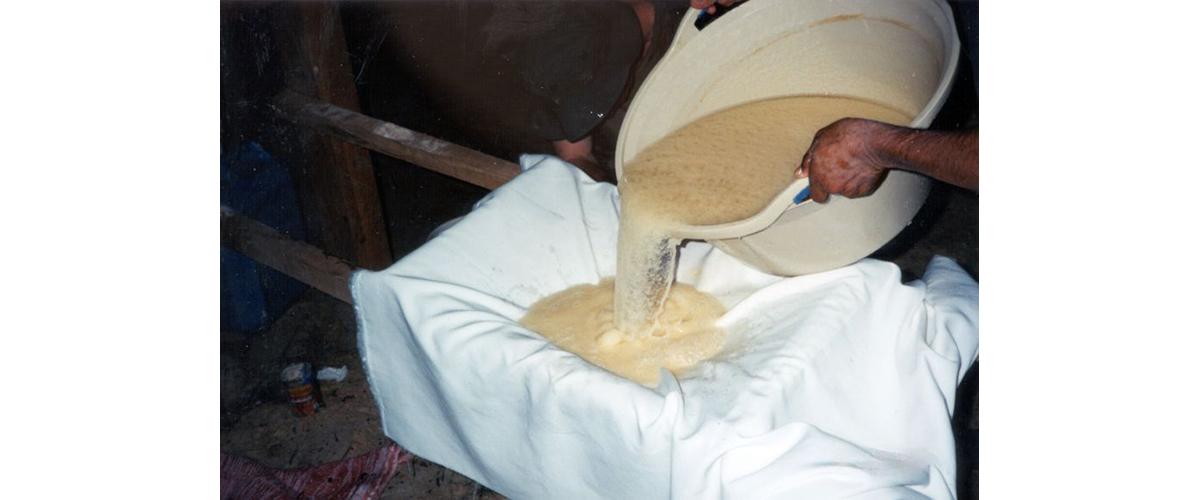 A person filtering cocaine through a cloth.