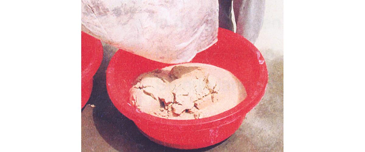 A bucket of tan heroin base