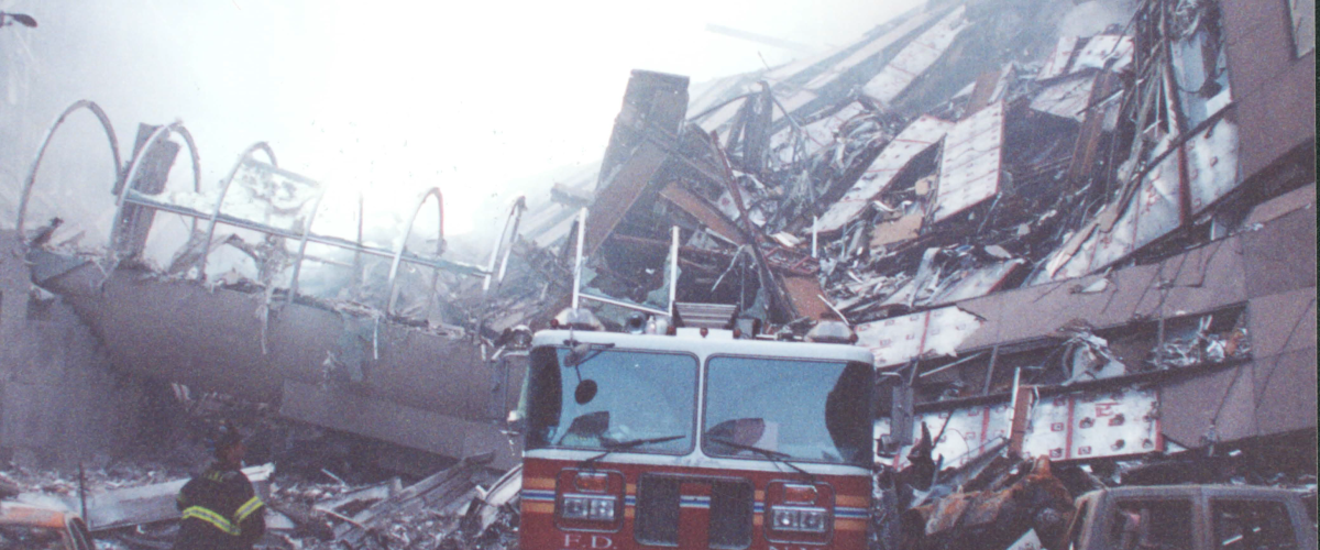A crushed firetruck beneath the rubble. DEA Photo.