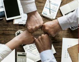 Hands fist-bumping when working together.