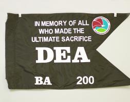 A black swallow-tailed flag with white lettering.